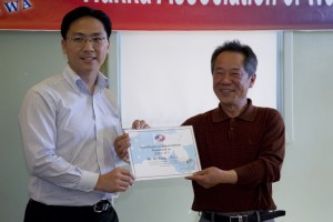 Organising Chairman Keith Yong presenting a Certificate of Appreciation to Mr. WANG Bo